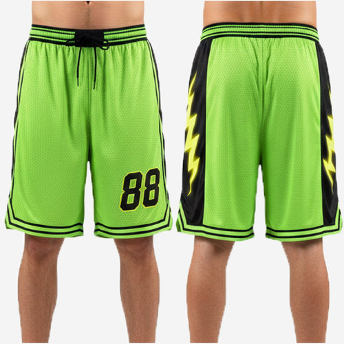 Close-up detail of sublimated black side panel with yellow lightning bolt graphic on neon green custom basketball shorts