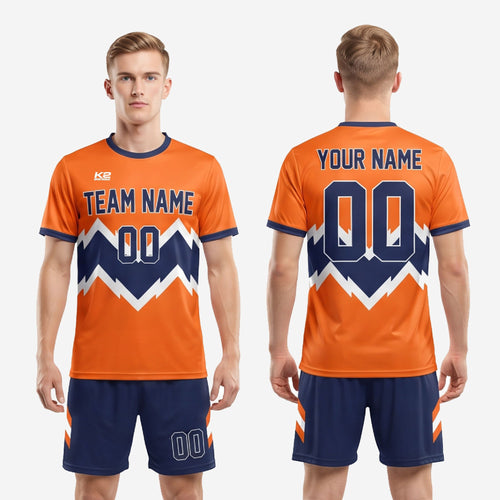 Full body overview of men's custom orange and navy soccer uniform kit with complete sublimated geometric design