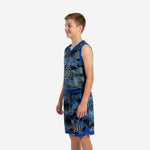 Side view of grey camo 12U basketball uniform showing royal blue armhole binding, shorts waistband, and hem trim