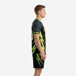 Custom all black soccer uniforms side view showing full neon green bolt graphic running from jersey to matching shorts