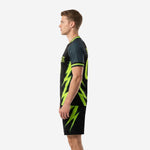 Sublimated all black soccer uniform right side view displaying neon green lightning bolt design on jersey and shorts