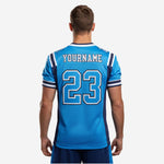 Detail side view of blue and navy football jersey highlighting two-stripe navy and white sleeve cuff bands and shoulder number placement