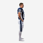 Custom navy football uniform packages side profile showing raglan sleeve line, white curved underarm panel on jersey, and full-length navy pant stripe running outer leg