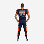 Opposite side view of navy and orange sublimated football uniform showing angular jersey panels and full-length orange pant stripe