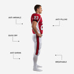 Detail view of sublimated red and white football uniform showing V-neck collar with black trim, sleeve cuff, and white curved shoulder panel