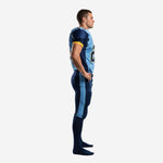 Side view of custom light blue and navy football uniform showing navy side panel on jersey and light blue leg stripe on pant