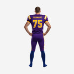 Back view of custom purple and gold football uniform for school programs showing player nameplate area and full-length purple pants with leg stripe