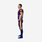 Reverse side view of purple and gold American football uniform showing sleeve number and side panel construction on jersey and pant stripe