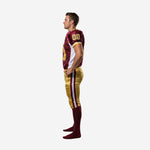 Side view of maroon and gold American football uniform showing white jersey side panel, set-in sleeve, and gold pant side stripe with maroon and white border