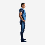 Side view of sky blue and navy sublimated football uniform showing navy shoulder panel set-in sleeve and dual blue stripes on full-length navy football pants