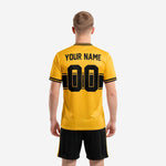 Back view of athletic gold and black custom soccer uniform kit with player name and number