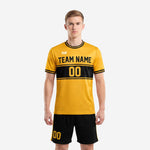 Athletic gold soccer jersey with black chest band and matching black shorts side stripe detail