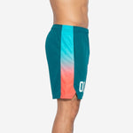 Side view of custom teal basketball shorts showing the full cyan-to-coral gradient fade on the side panel from waistband to hem split