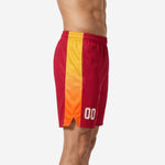 Side view of custom red basketball shorts showing the full-length gold-to-orange gradient side panel running from elastic waistband to hem split
