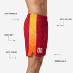 Close detail of the gold-to-orange gradient side panel and hem split on red custom basketball shorts