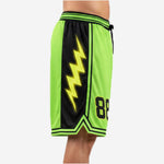 Side view of neon green custom basketball shorts with side panels featuring large yellow lightning bolt graphic on black panel