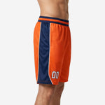 Left side view of orange basketball shorts showing full-length navy side panel with white trim stripe from waistband to hem