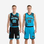 Shorts detail of the black and cyan reversible basketball uniform showing hem binding, waistband accent, and front number