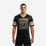 Black and gold football jerseys with sublimated team name and front number 23, gold mesh side panels and V-neck collar, adult male model front view