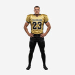 Custom black and gold football uniforms front view showing gold jersey with black side panels and team name number 23 above matching black pants with gold side stripe