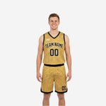 Front view of the black side of the custom reversible basketball uniform with arced team name in gold and number 00 on the chest and shorts leg