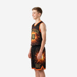 Right side view of black and gold youth basketball uniform showing orange armhole binding and sublimated spark design on shorts panel
