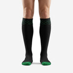 Front view of custom black and green soccer socks with Kelly Green diamond geometric cuff pattern and contrast toe cap