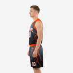 Right side view of black and orange sublimated basketball uniform showing orange armhole binding and lightning bolt design on jersey and shorts