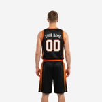 Back view of custom black and orange basketball uniforms showing back name and number placement on fully sublimated black jersey with orange armhole binding
