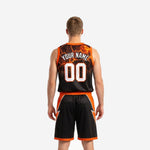 Back view of black and orange custom basketball uniform showing player name and number placement on jersey