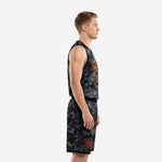 Front view of custom black and orange basketball uniform set with arched team name and number on V-neck digital-camo jersey