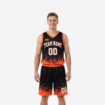 Black and orange basketball uniforms full two-piece set with pixel-scatter gradient design, team name arc and front number on male model