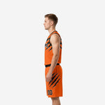 Left side view of orange and black sublimated basketball uniform showing armhole binding and claw graphic placement