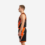 Opposite side view of black and orange basketball uniform set showing armhole binding and waistband detail