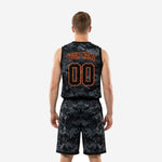 Opposite side view of black and orange basketball uniform set showing armhole binding and camo shorts hem detail