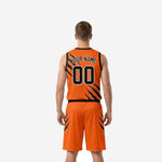 Right side view of the orange and black custom basketball uniform set with diagonal slash panel and black waistband