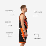 Close detail of black and orange basketball shorts with orange lightning bolt graphic and orange hem band