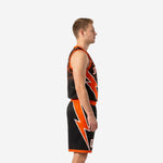 Side view of black and orange sublimated basketball uniform with orange lightning bolt panel on shorts left leg