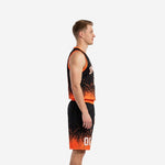 Side view of black and orange sublimated basketball uniform showing armhole binding and gradient short hem on male player