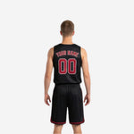 Opposite side view of red and black reversible basketball uniform set showing slash pattern detail on jersey and shorts
