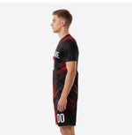 Side profile of black and red soccer kit with sublimated diagonal stripe pattern on jersey and coordinating shorts with player number