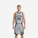 Front view of custom black and white reversible basketball uniform with arced team name, front number, and silver-grey side panel contrast trim