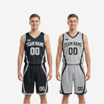 Close-up detail of V-neck collar and armhole binding on black and white reversible basketball jersey with contrast silver-grey trim