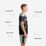 Silver soccer shorts with black contrast side panels and sublimated drip graphic detail, part of custom black and white soccer uniform set
