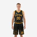 Custom black and yellow basketball uniforms front view showing damask pattern jersey and matching shorts with gold trim and team name