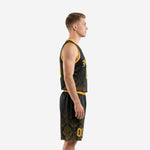 Side view of black and yellow basketball uniforms showing V-neck binding, armhole trim, and damask print on jersey and shorts