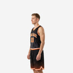 Side view of black and orange basketball uniform showing flat armhole binding and chevron hem on shorts
