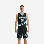 Black and blue reversible basketball uniforms showing black side front and sky-blue reverse side front on a male model, diagonal swirl panel detail visible