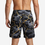 Back view of custom black basketball shorts with gold camo pattern, showing back number placement zone for personalized team orders
