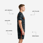 Black camo soccer jersey detail showing orange side panel stitching and V-neck collar trim